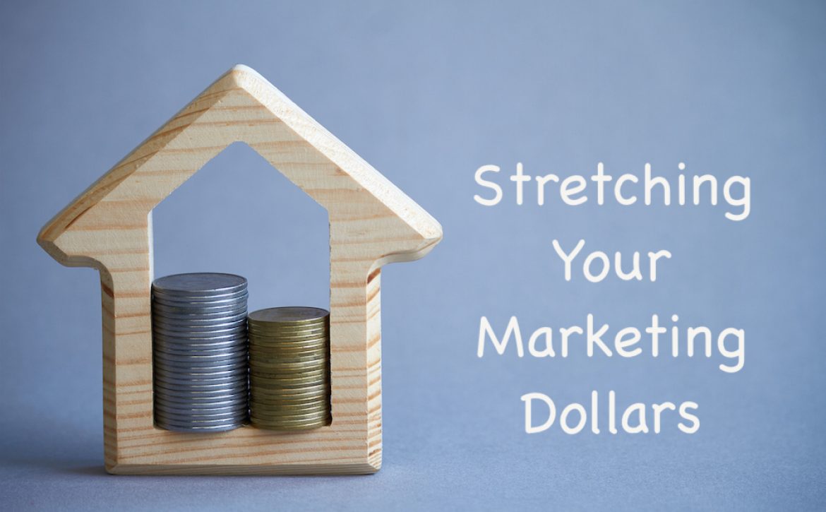 Wooden figurine of house and two columns of coins inside on gray background, the concept of buying or renting a building, eco-friendly to the environment, selective focus